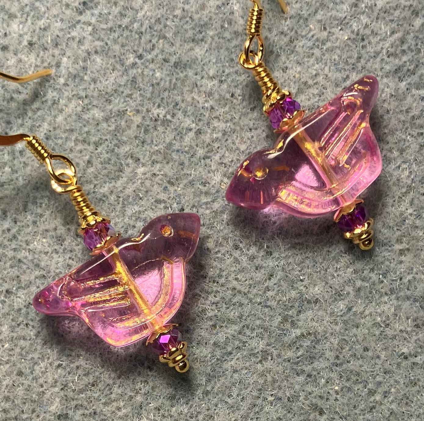 Translucent violet (with gold wash) Czech glass bird bead earrings adorned with violet Chinese crystal beads.
