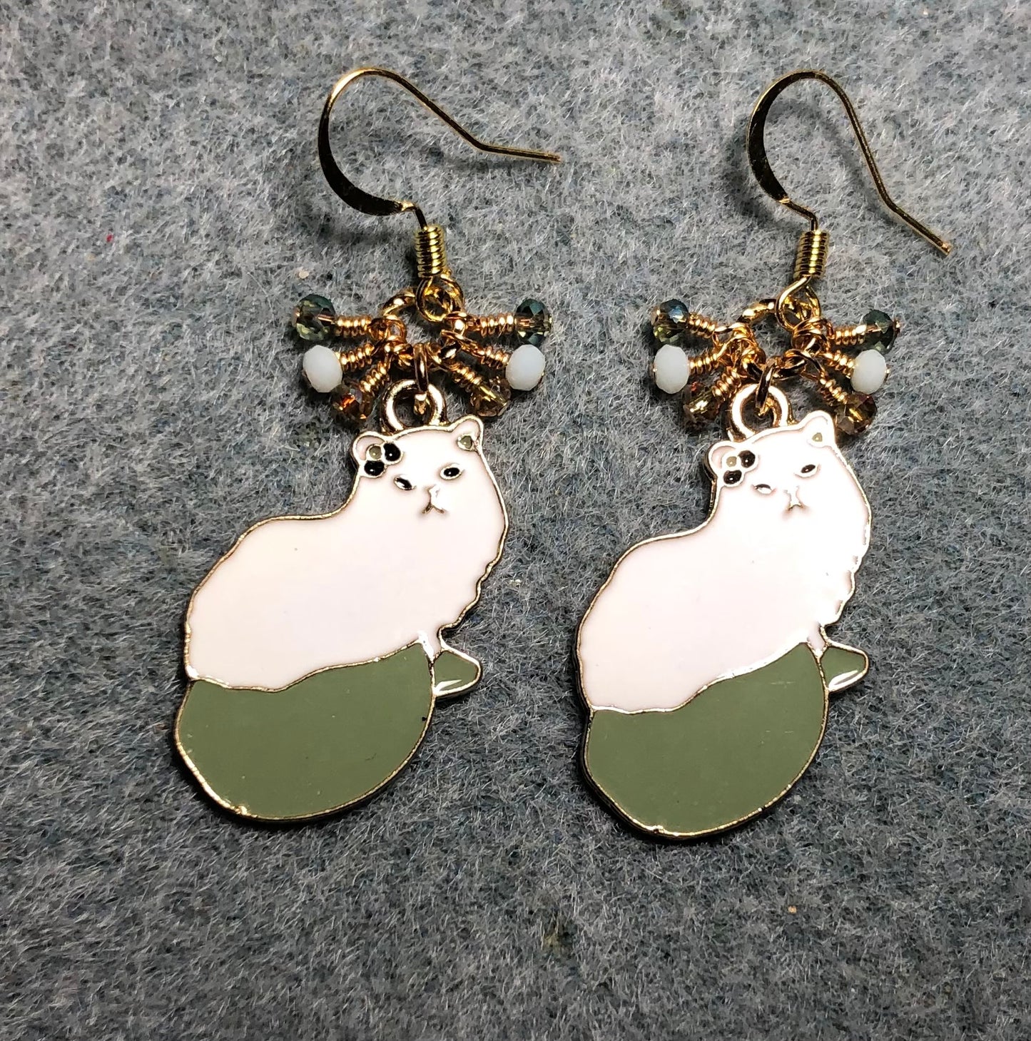 White and olive green enamel cat charm earrings adorned with tiny dangling white and olive green Chinese crystal beads.