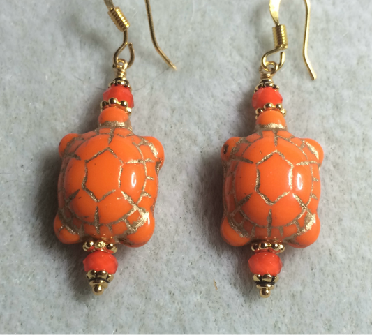 Opaque orange (with gold inlay) Czech glass turtle bead earrings adorned with orange Chinese crystal beads.