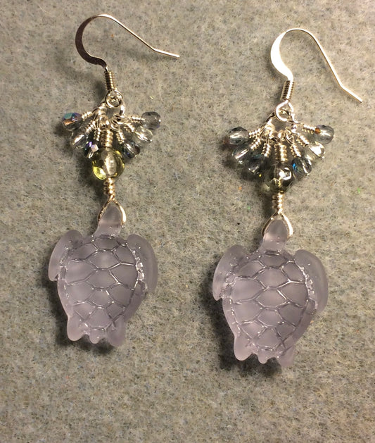 Translucent light violet sea glass sea turtle bead earrings adorned with clear Czech glass beads and small dangling light violet Czech glass beads.