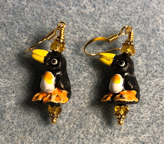 Black, tangerine, and amber ceramic penguin bead earrings adorned with amber Chinese crystal beads.