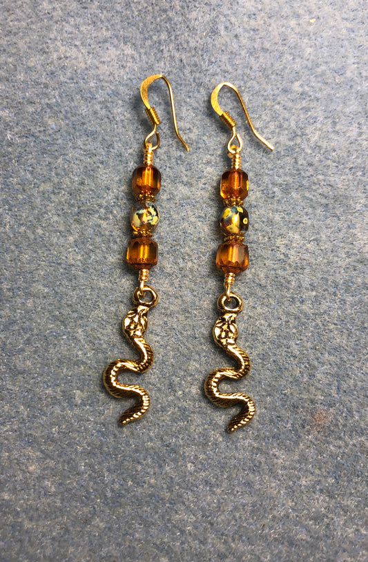 Gold snake charm earrings adorned with amber Czech glass beads