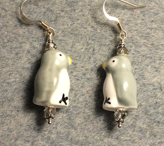 Gray and white ceramic penguin bead earrings adorned with gray Chinese crystal beads.