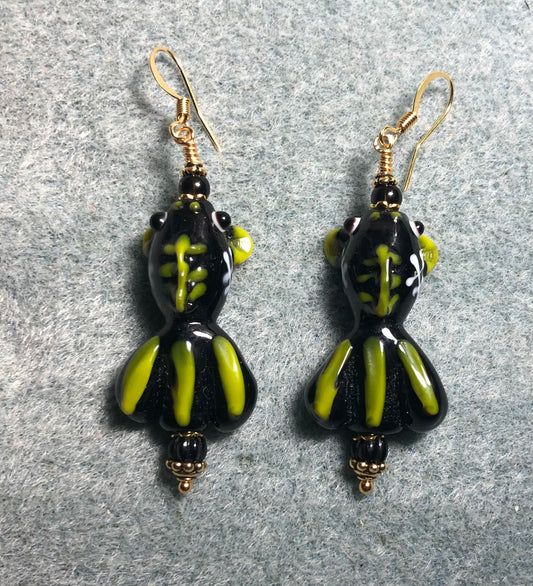 Black and yellow lamp work striped fish bead earrings adorned with black Czech glass beads.