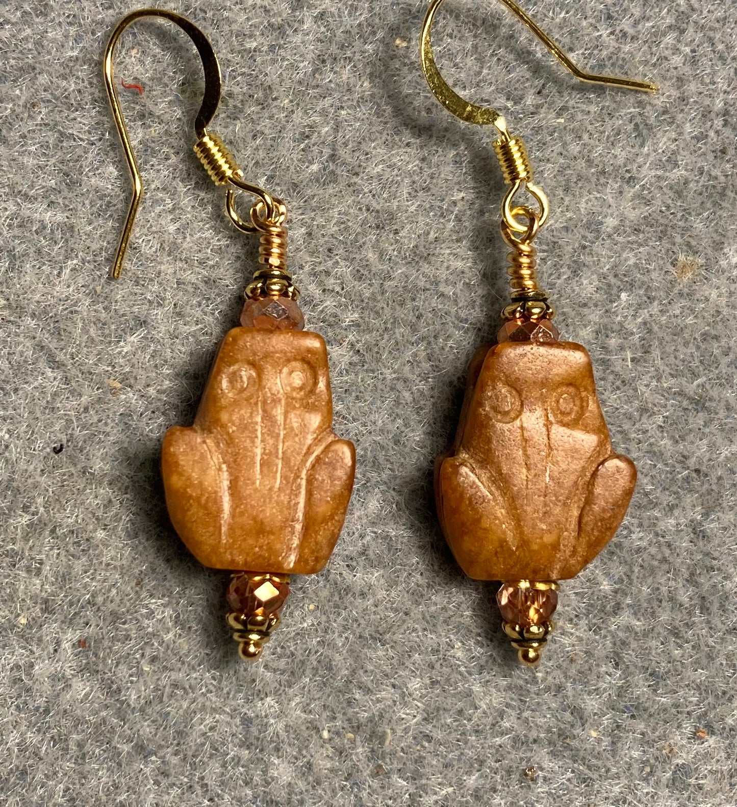 Carved orange jade gemstone frog bead earrings adorned with orange Chinese crystal beads.