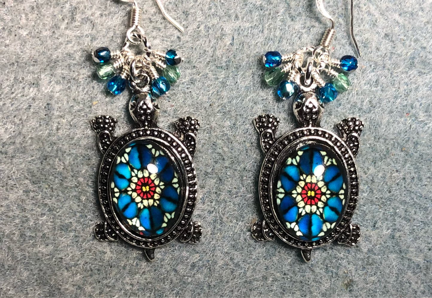 Large silver and turquoise and green glass stone turtle charm earrings adorned with small dangling turquoise and green Czech glass beads.