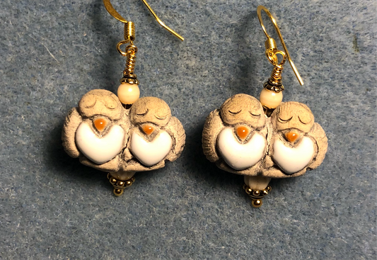 Medium beige and off white ceramic pair of lovebird bead earrings adorned with off white Czech glass beads.