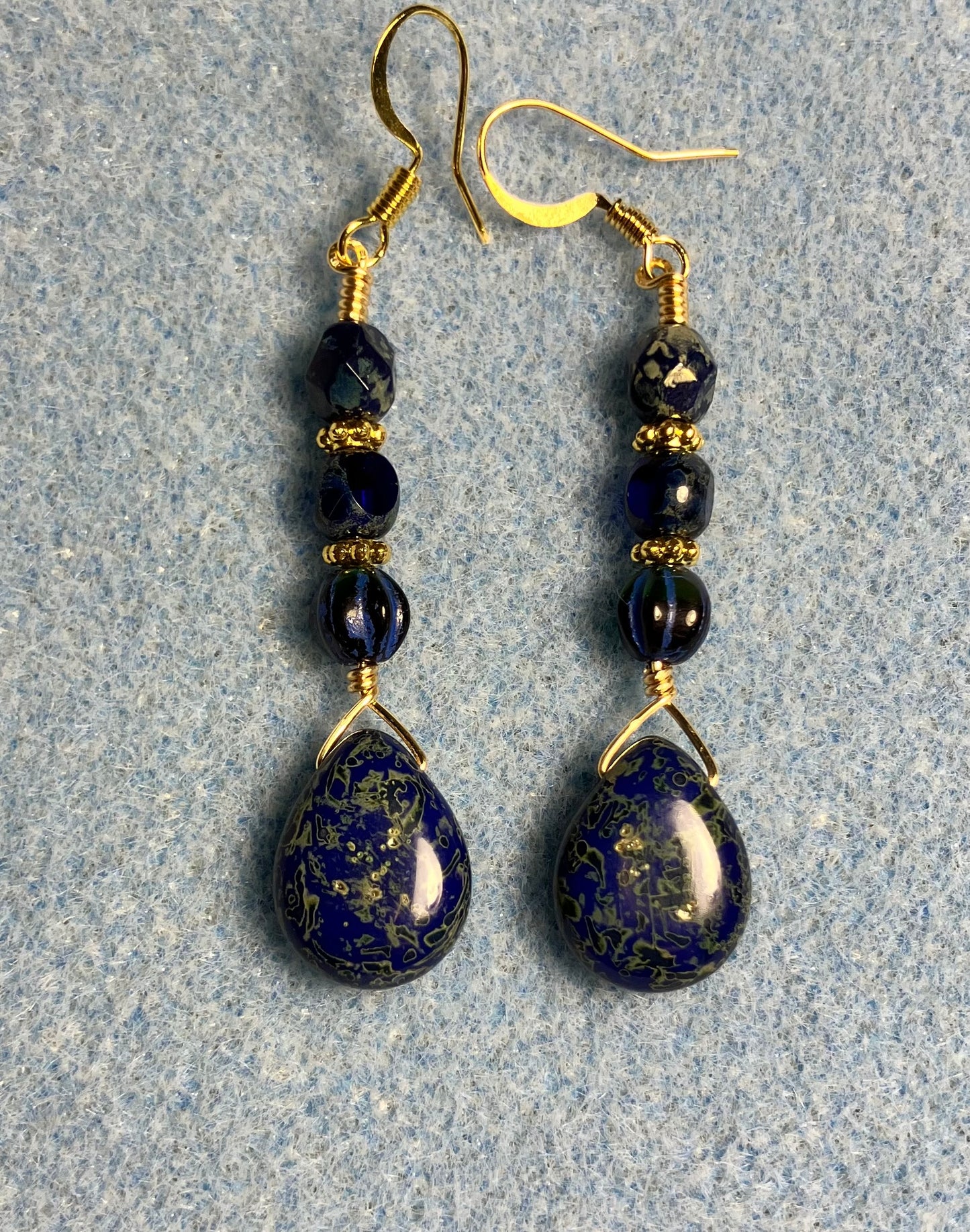 Dark blue Picasso Czech glass pear drop bead earrings adorned with dark blue Picasso Czech glass beads.