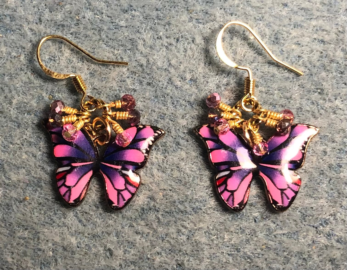 Pink and purple enamel butterfly charm earrings adorned with tiny dangling pink and purple Chinese crystal beads.