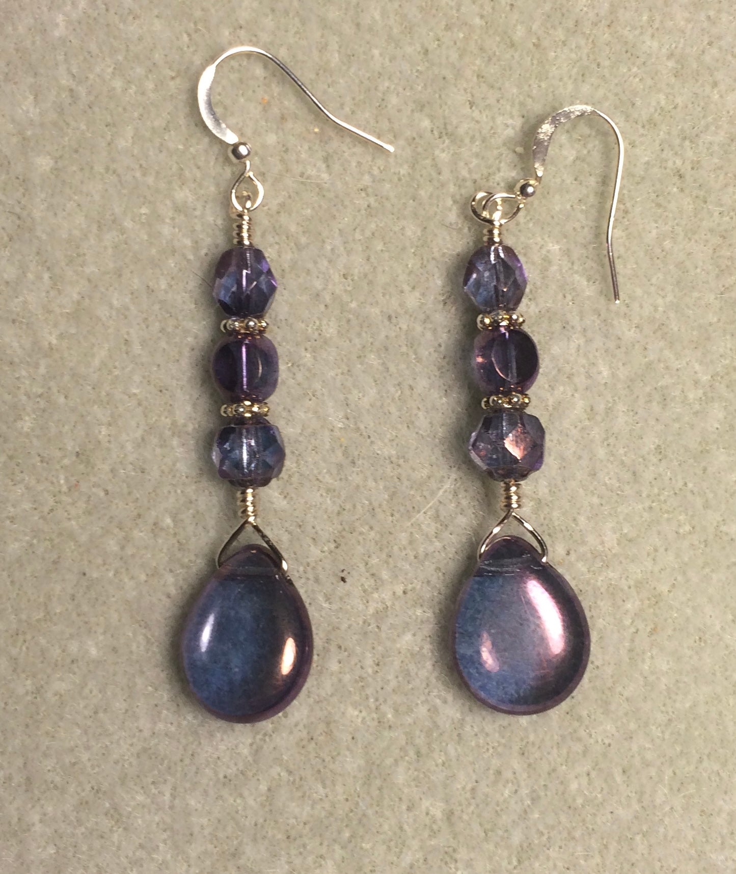 Purple Czech glass pear drop bead earrings adorned with purple Czech glass beads.