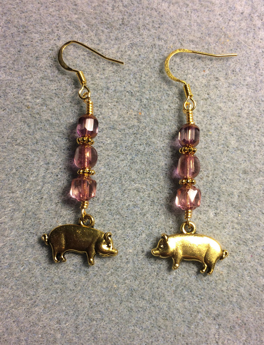 Gold pig charm earrings adorned with pink Czech glass beads