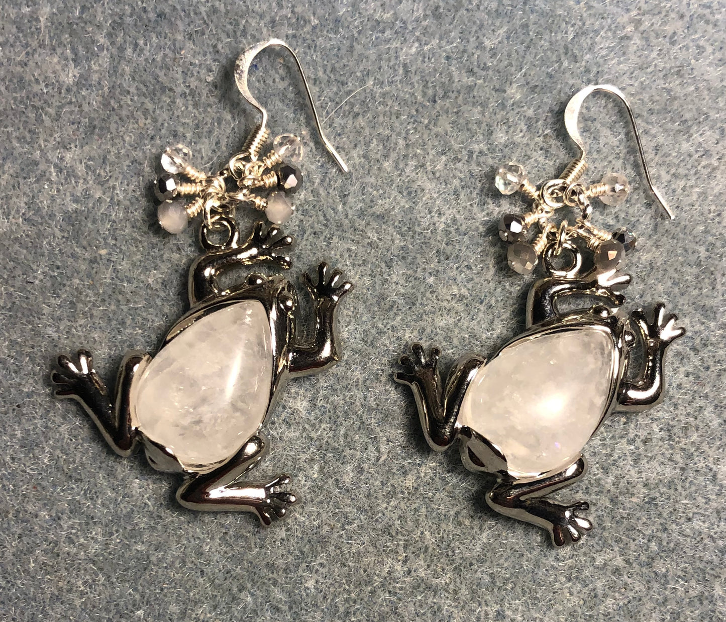 Large silver and rock crystal gemstone frog charm earrings adorned with small dangling white, silver, and clear Chinese crystal beads.