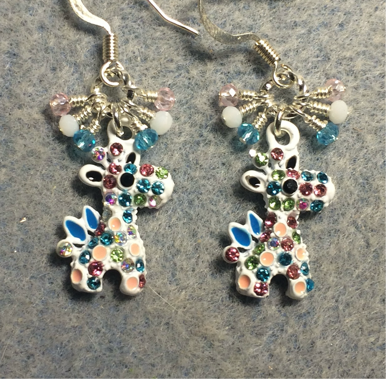 White and colorful rhinestone giraffe charm earrings adorned with tiny dangling pink, white, and turquoise Chinese crystal beads.