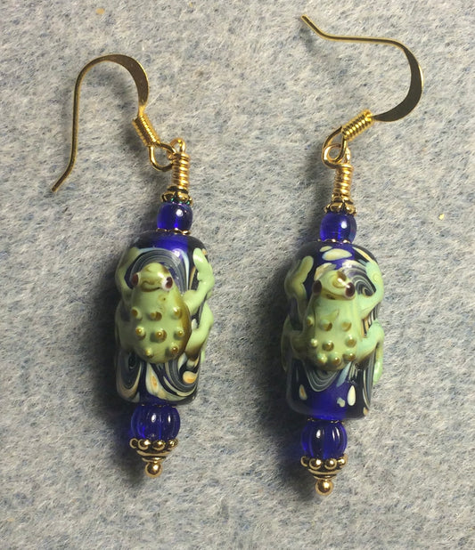 Bright blue and green lamp work frog bead earrings adorned with dark blue Czech glass beads.