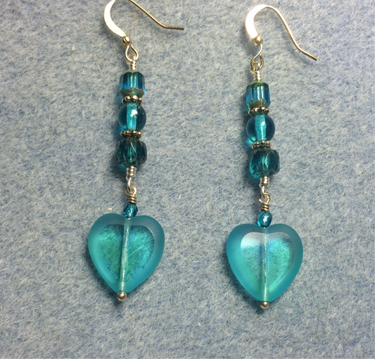 Turquoise teal Czech glass heart bead earrings adorned with turquoise Czech glass beads.