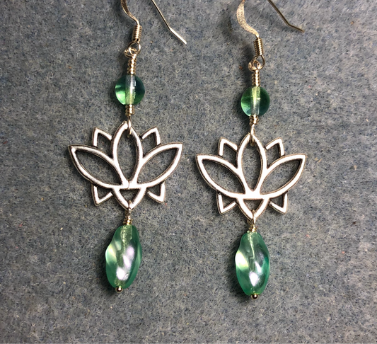 Silver lotus flower connector charm earrings adorned with light green Czech glass drop beads and light green Czech glass beads.