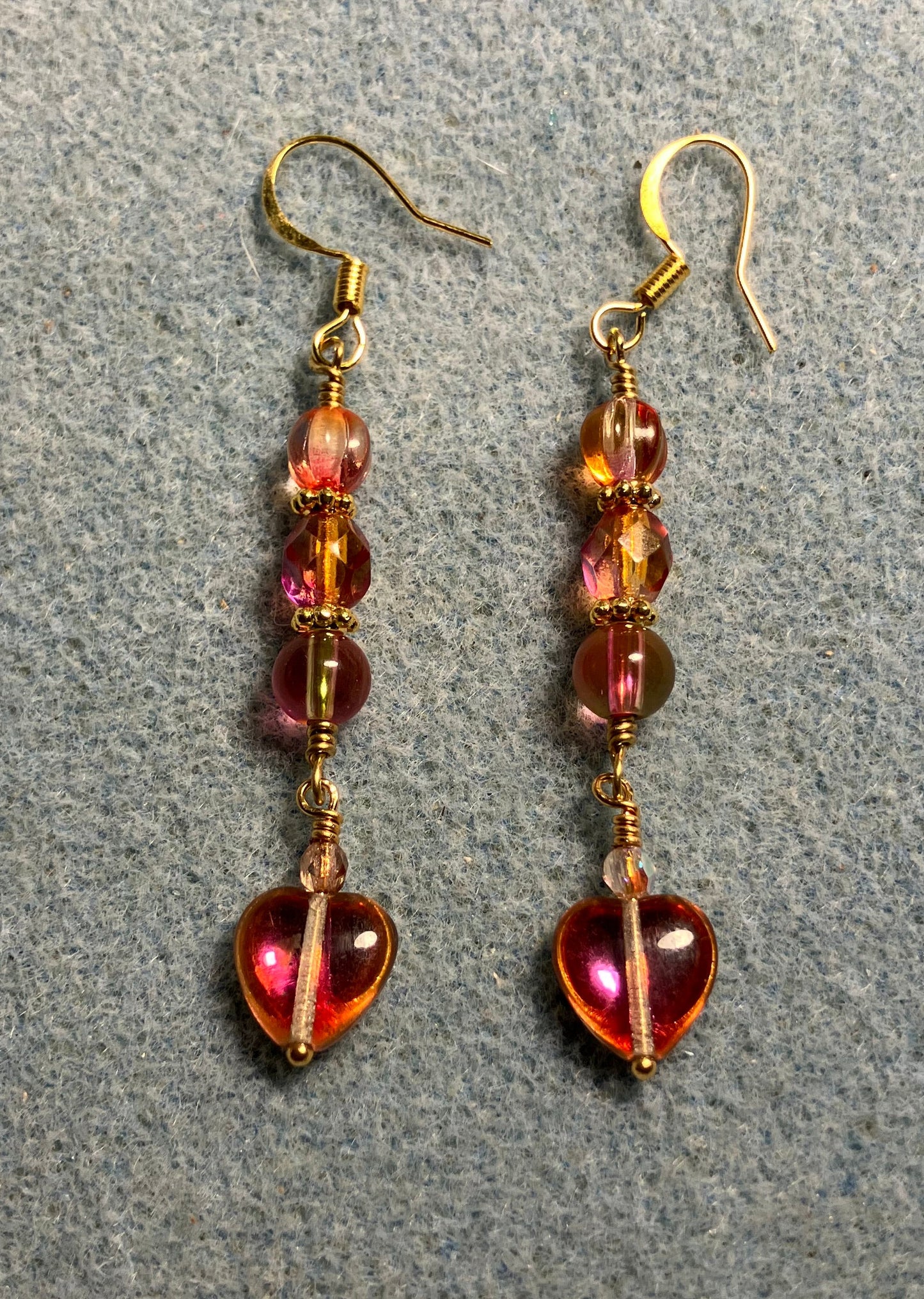 Small pinkish orange Czech glass heart bead earrings adorned with pinkish orange Czech glass beads.