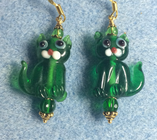 Translucent emerald green lamp work cat bead earrings adorned with emerald green Czech glass beads.