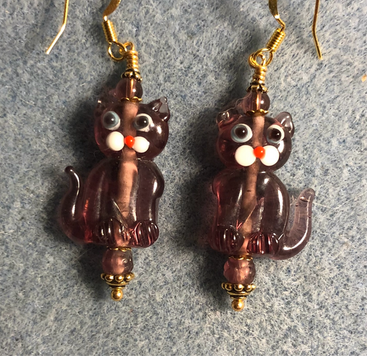 Translucent violet lamp work cat bead earrings adorned with violet Czech glass beads.