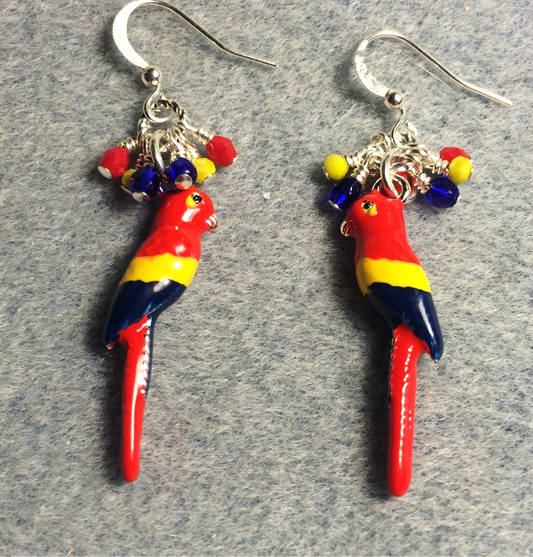 Red, blue, and yellow enamel macaw charm earrings adorned with tiny dangling red, blue, and yellow Czech glass beads.