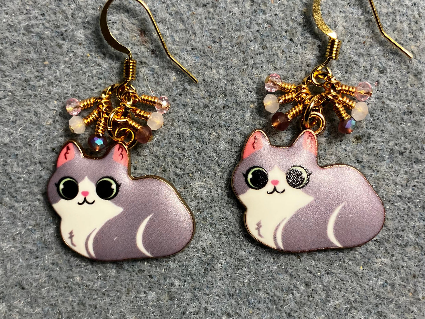 Violet, white, and pink enamel cat charm earrings adorned with tiny dangling violet, white, and pink Chinese crystal beads.
