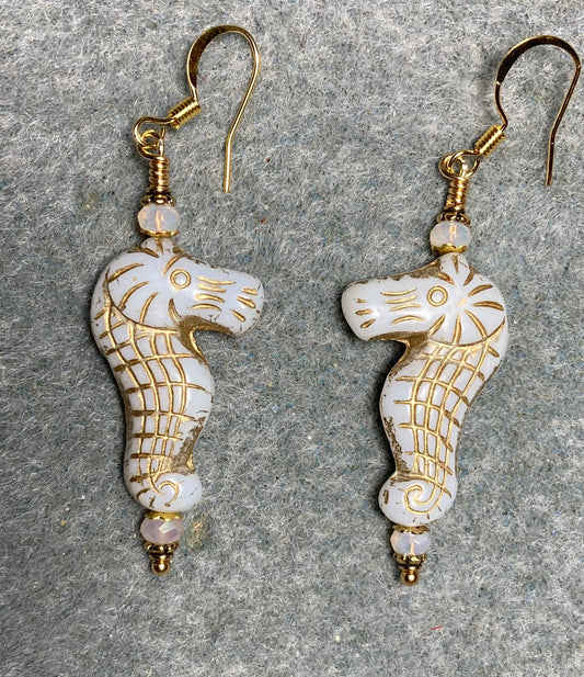 White (with gold inlay) Czech glass seahorse bead earrings adorned with white Chinese crystal beads.