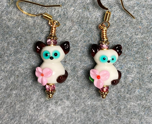 Small brown, white, pink, and turquoise lamp work cat bead earrings adorned with pink Chinese crystal beads.