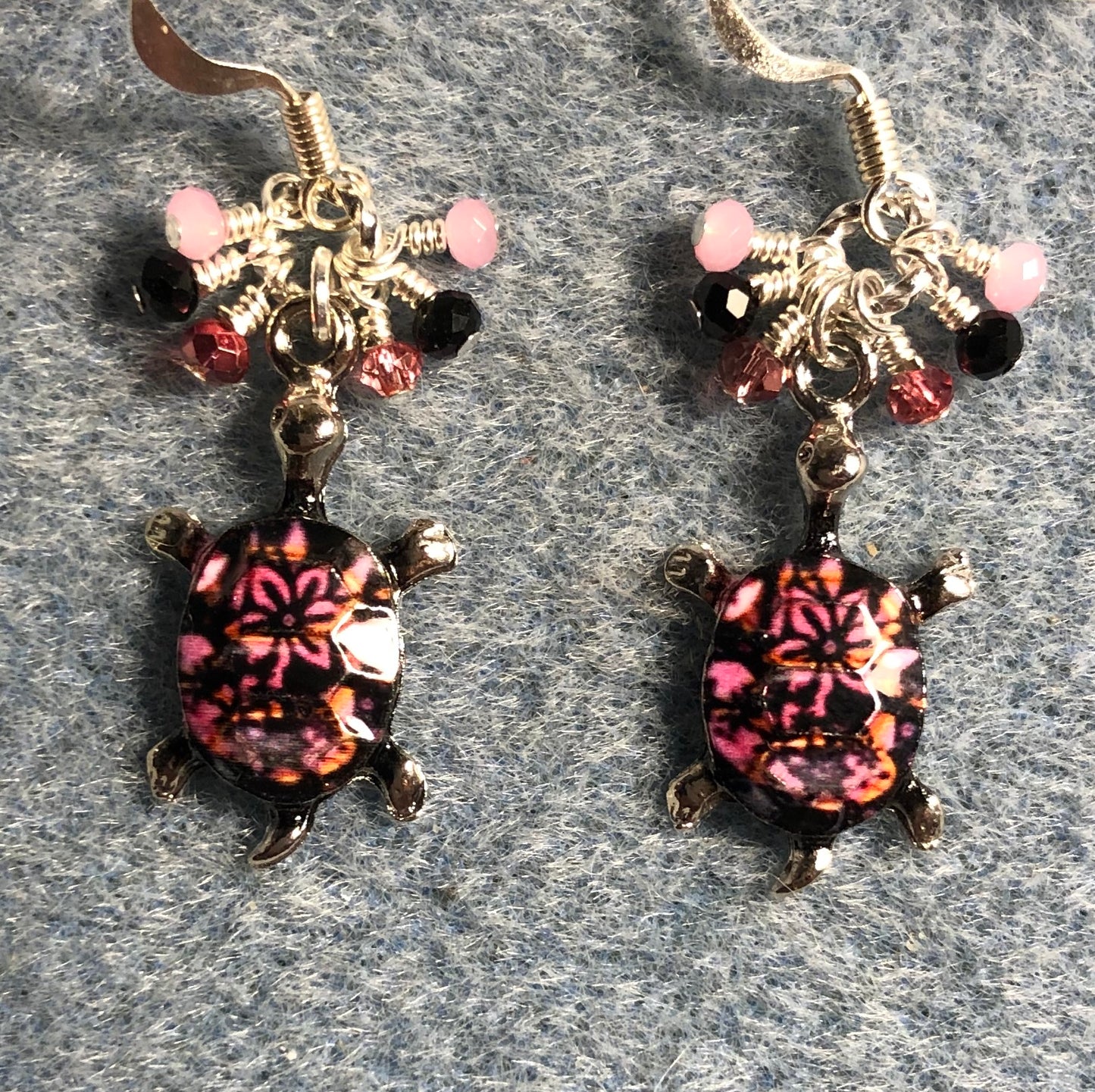 Rose pink and black enamel turtle charm earrings adorned with tiny dangling rose pink, black, and light pink Chinese crystal beads.