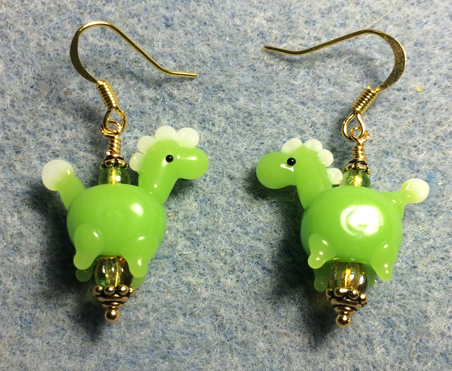 Opaque lime green lamp work horse bead earrings adorned with lime green Czech glass beads.
