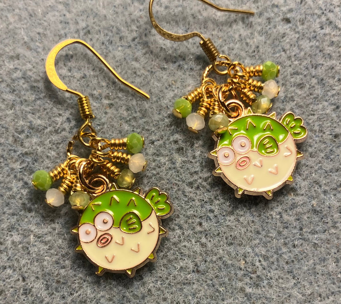 Small lime green enamel blowfish charm earrings adorned with tiny dangling lime green and white Chinese crystal beads.