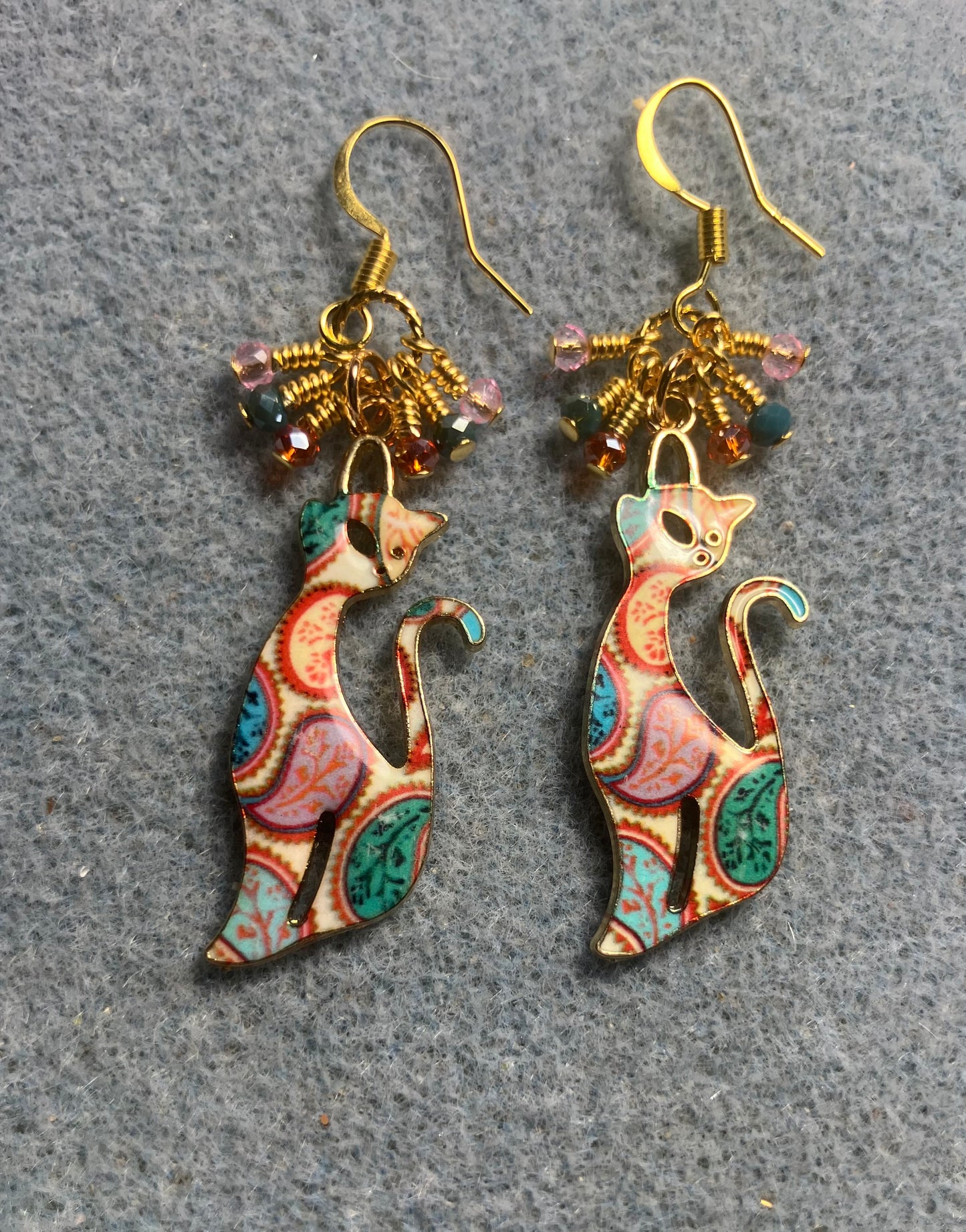 Pink, teal, and orange enamel paisley patterned cat charm earrings adorned with tiny dangling pink, teal, and orange Chinese crystal beads.