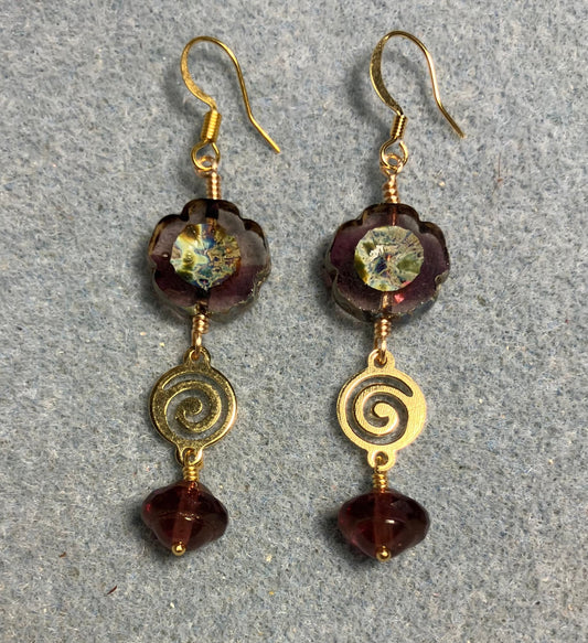 Translucent violet Czech glass pansy bead earrings adorned with gold swirly connectors and violet Czech glass Saturn beads.