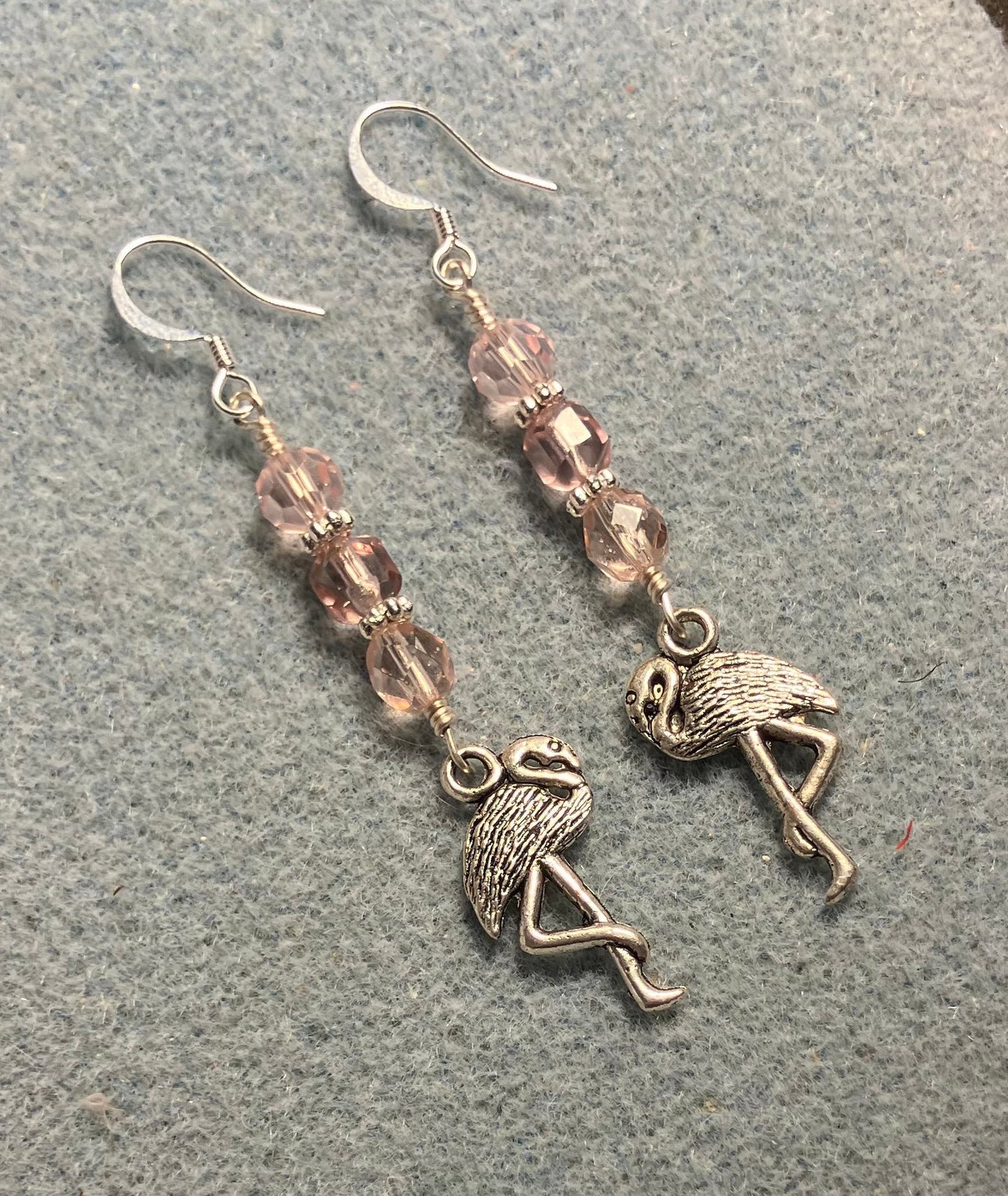 Silver flamingo charm earrings adorned with light pink Czech glass beads