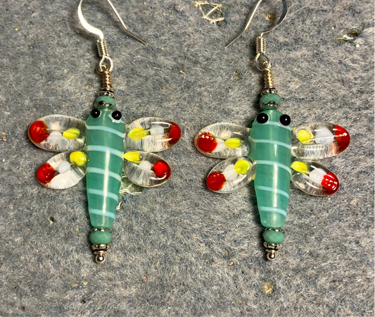 Aqua green, red, and yellow lamp work dragonfly bead earrings adorned with aqua green Chinese crystal beads.