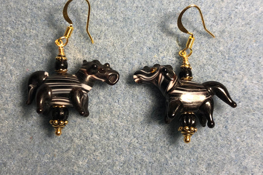 Black with white stripes lamp work horse bead earrings adorned with black Czech glass beads.
