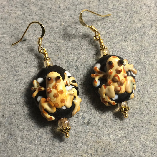 Black and tan lamp work frog bead earrings adorned with tan Czech glass beads.