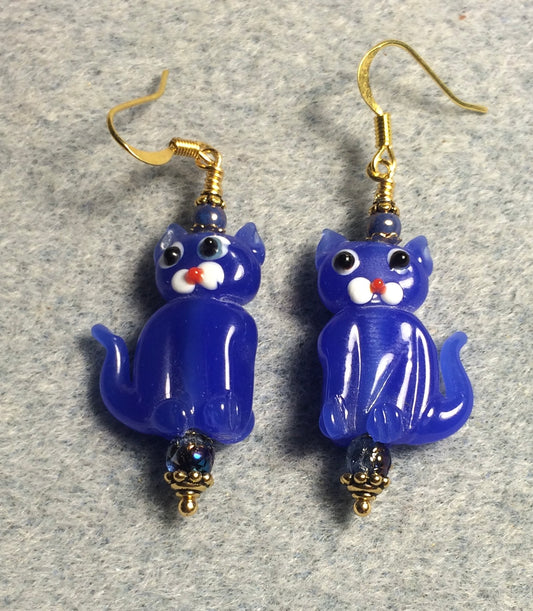 Opaque bright blue lamp work cat bead earrings adorned with bright blue Czech glass beads.