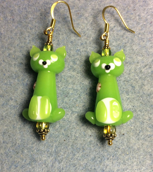 Opaque lime green lamp work cat bead earrings adorned with lime green Czech glass beads.