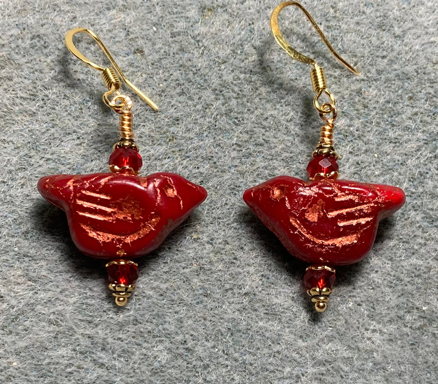 Dark red (with copper wash) Czech glass bird bead earrings adorned with dark red Chinese crystal beads.