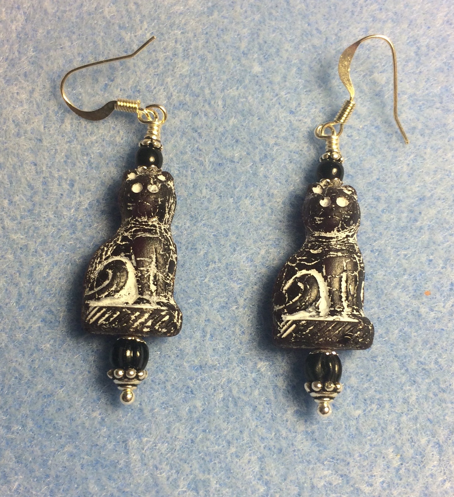 Black (with white inlay) fancy Czech glass cat bead earrings adorned with black Czech glass beads.