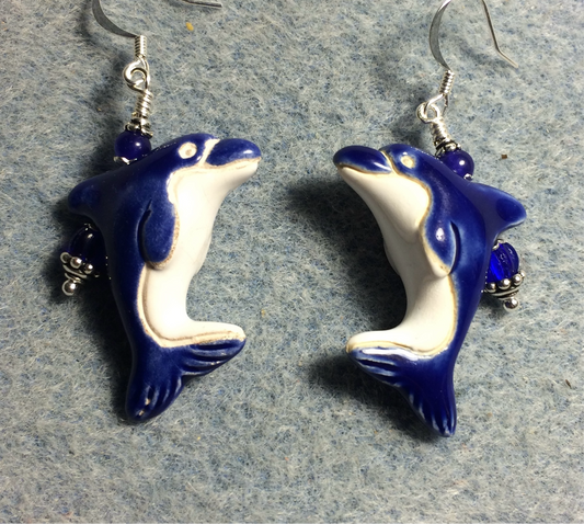 Dark blue and white ceramic dolphin bead earrings adorned with dark blue Czech glass beads.