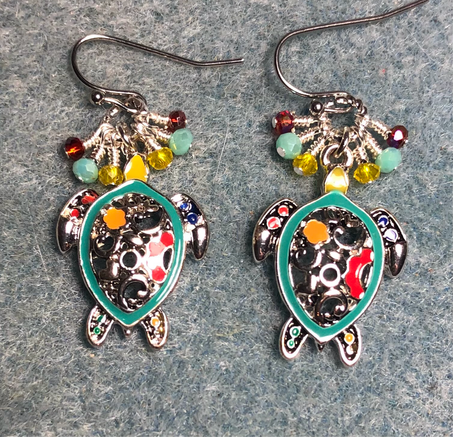 Silver and aqua, red, and yellow enamel sea turtle charm earrings adorned with small dangling aqua, red, and yellow Chinese crystal beads.