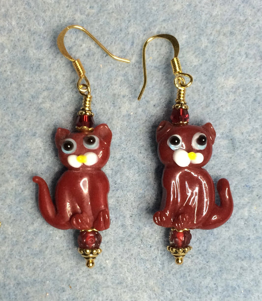 Opaque dark red lamp work cat bead earrings adorned with dark red Czech glass beads.