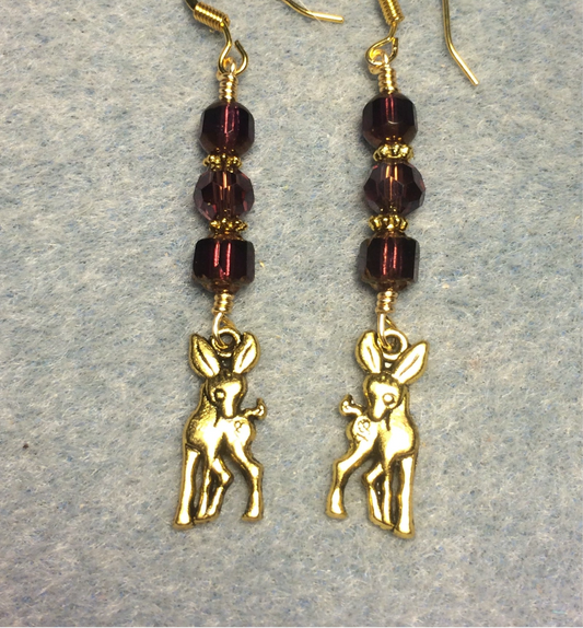Gold deer charm earrings adorned with purple Czech glass beads.
