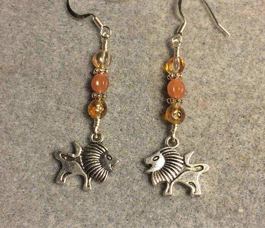 Small silver lion charm earrings adorned with small amber and orange Czech glass beads