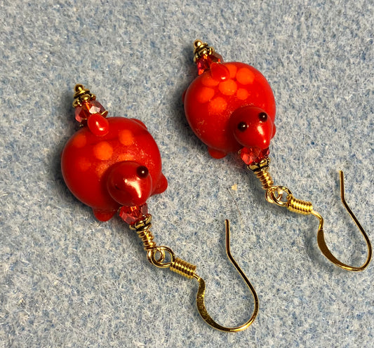 Red with orange spots lamp work turtle bead earrings adorned with red Chinese crystal beads.