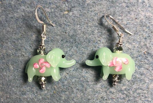 Opaque light green and pink lamp work elephant bead earrings adorned with light green Chinese crystal beads.