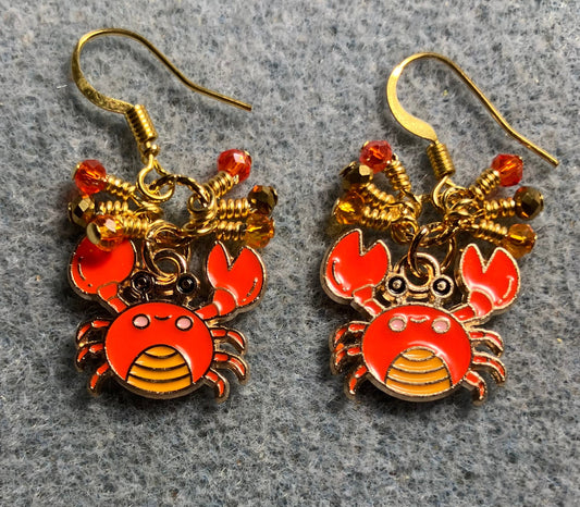 Small orange and gold enamel crab charm earrings adorned with tiny dangling orange and gold Chinese crystal beads.