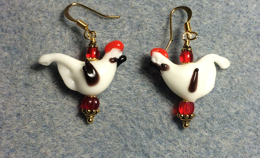 Opaque white and brown lamp work songbird bead earrings adorned with red Czech glass beads.
