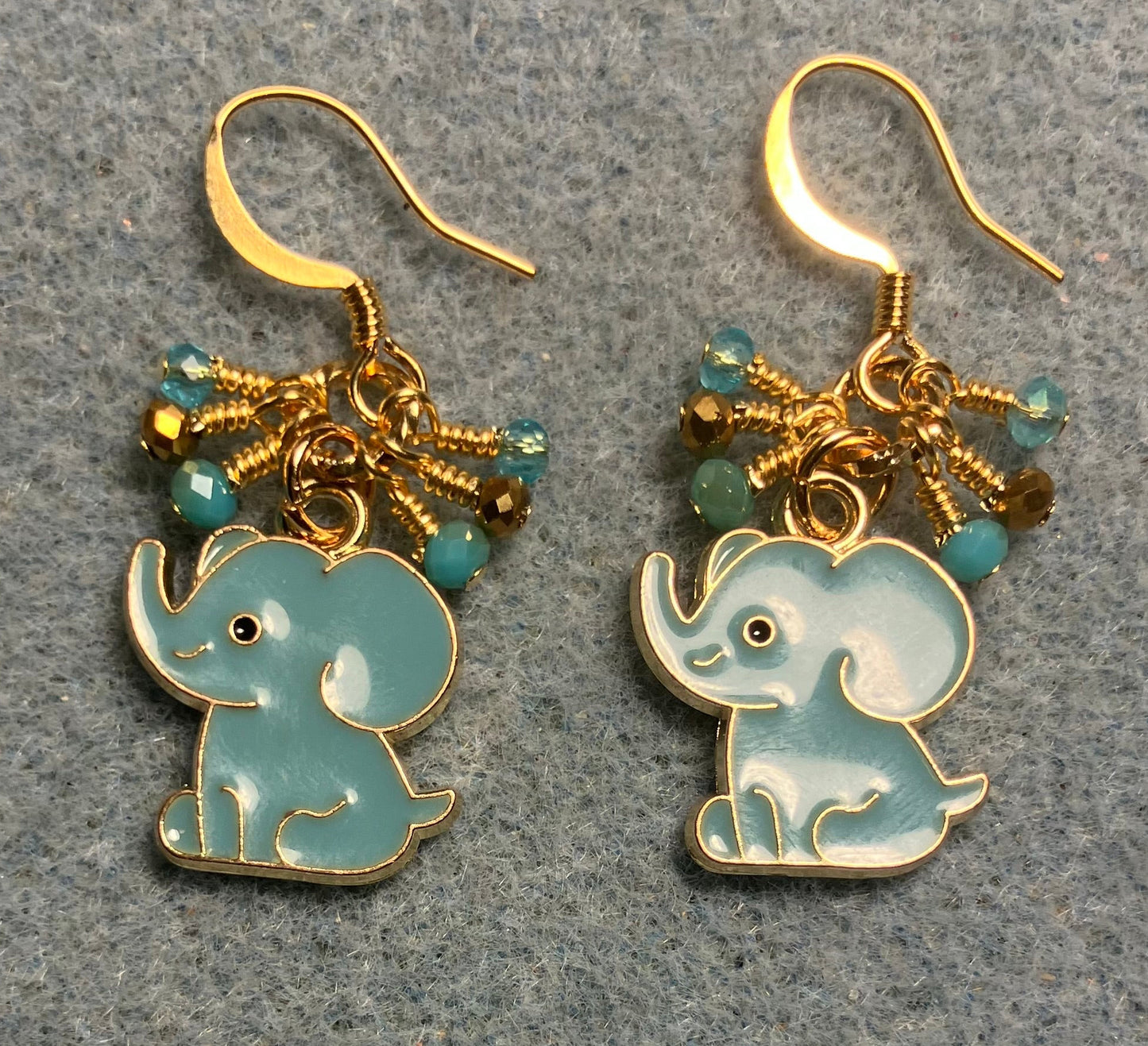 Aqua and gold enamel elephant charm earrings adorned with tiny dangling aqua and gold Chinese crystal beads.